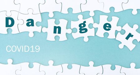 Danger Covid-19, Close up view puzzle on blue
