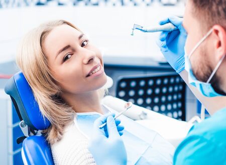 Dentist treating blond smiling girlの写真素材