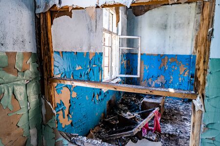 Ruined corridor with piles of garbage in abandoned buildingの写真素材