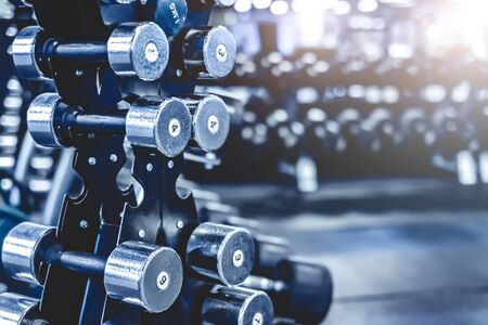 rack with a set of metall dumbbells in the gymの写真素材