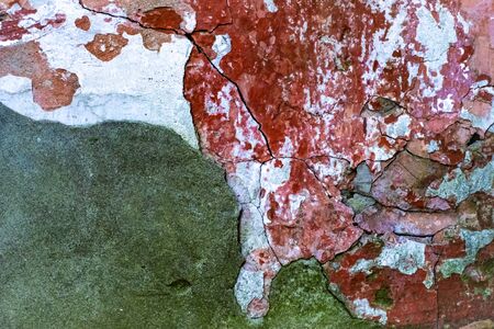 Decayed old white wall with red bricks, backgroundの写真素材