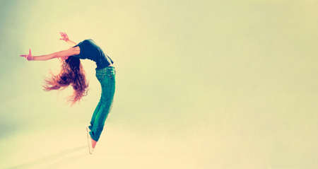young and beautiful dancer posing in studio with copy spaceの写真素材