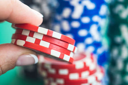 Poker chips for bet in woman handの写真素材