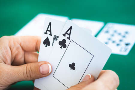 Pair of aces in hands of gambler