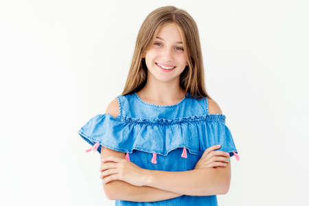 Girl with crossed arms isolated on white backgroundの写真素材