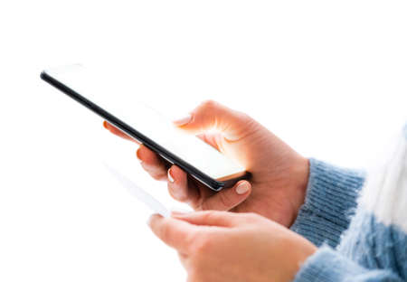 Dialing number from business card on mobile phone isolated on a white background