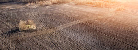 Panoramic view of plowed field at sunshineの写真素材