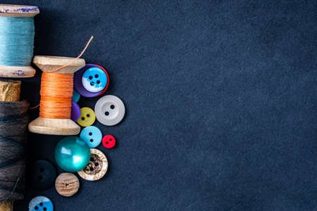 Heart made of retro thread spools and bright sewing buttons with copy spaceの写真素材