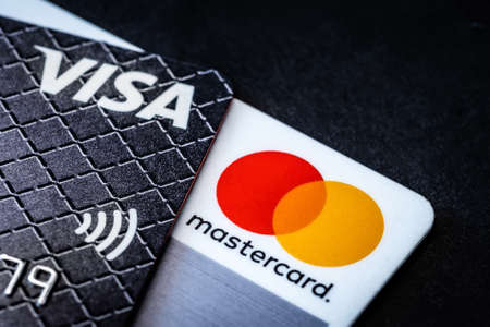 Kyiv, Ukraine - 03 June 2020: Credit cards Visa and Mastercard on blackのeditorial素材