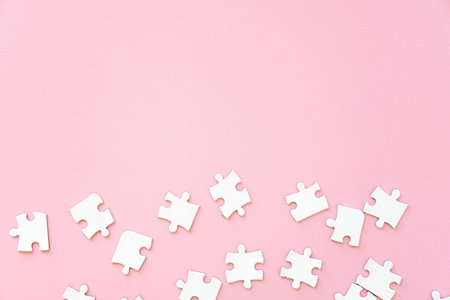 White jigsaw puzzle pieces on pink, top view copy cpaceの写真素材