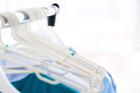 Row of white clothes hangersの写真素材