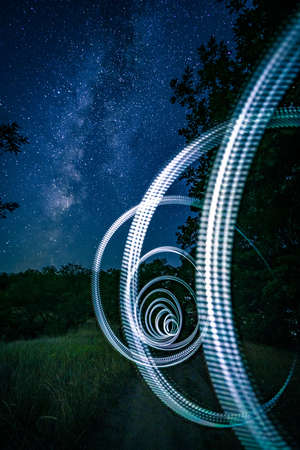 Illuminated arcs made of light at starry nightの写真素材