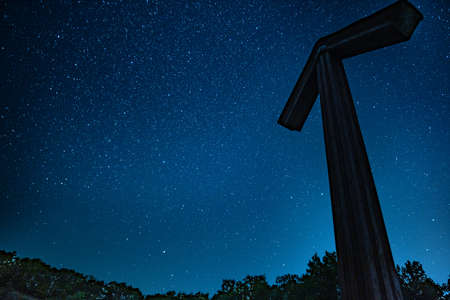 Arrow silhouette under stars in night sky