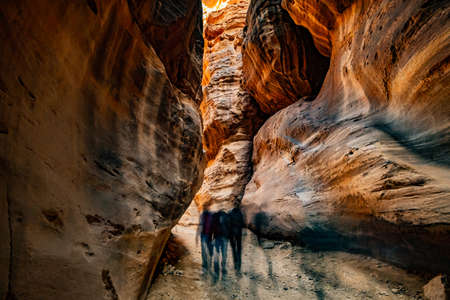 Group of people between sandstone rocks at narrow path in Petra, Jordanの写真素材