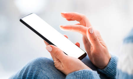 Woman using smartphone in light room
