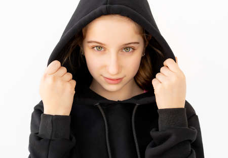 Portrait of cute girl in black hood isolated on white backgroundの写真素材
