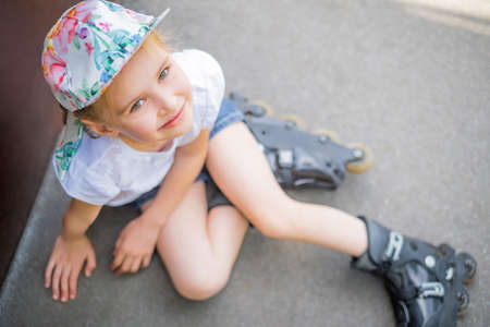 Beautiful little girl on roller skates in park, top viewの写真素材