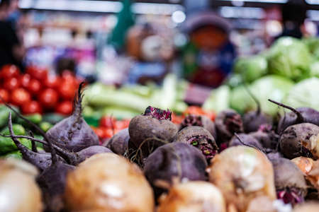 Beet and onion in shop. Colorful raw vegetables sold on grocery market. Natural organic veggies at supermarket. Vegetarian healthy nutritionの写真素材