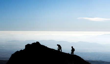 Silhouette of hikers on mountain topの写真素材