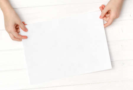 Empty blank sheet of paper in hands