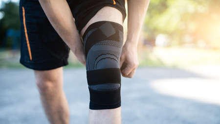 Knee support brace on male legsの写真素材