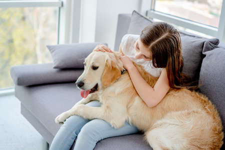 Sweet girl holding cute dogの写真素材