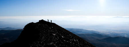 Silhouette of hikers on mountain top