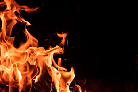 Fire flame isolated on black backgroundの写真素材