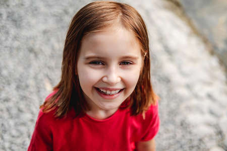 Smiling little girl looking upの写真素材