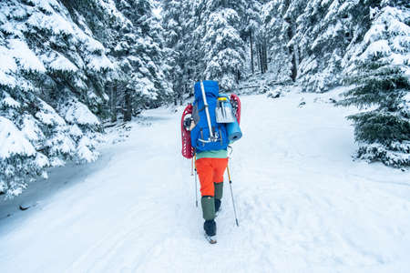 tourist with equipment for spending night in winter mountainsの写真素材