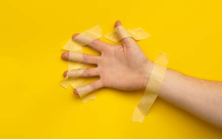Hand with masking tapeの写真素材