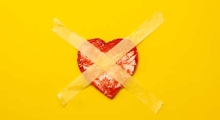 Heart sticked up with masking tapeの写真素材