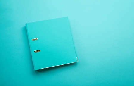 Hardcover folder on blue backgroundの写真素材