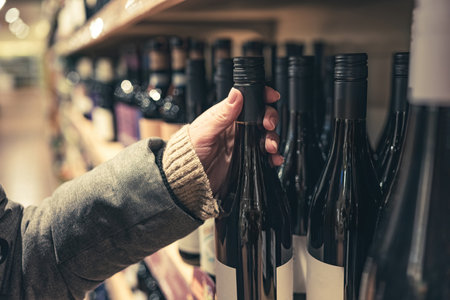 Woman choosing wine in market for winter new year's mulled wineの写真素材
