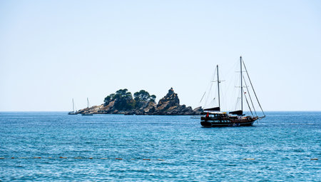 Touristic boat in Adriatic sea in Montenegro close to island in sunny day. Beautiful Mediterranean...