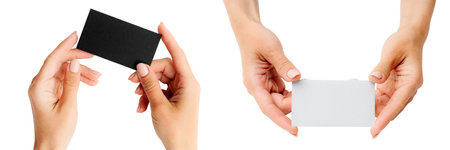 Set of white and black business cards in girls hands isolated on a white background