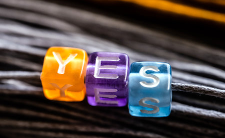 Colorful lucky die with word yes as sign of fortune. Three cubes as concept of success and opportunityの写真素材