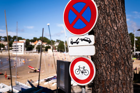 Warning sign with bicycle and cars on beach with sea shore view. Bike and transportation restriction notice on ocean coastの写真素材