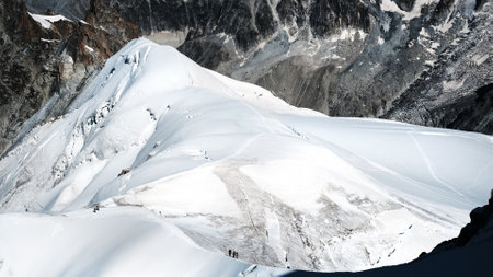 Montblanc Climbing, Hiking Group Passing By Snowy Path Along The Mountain Rangeの写真素材