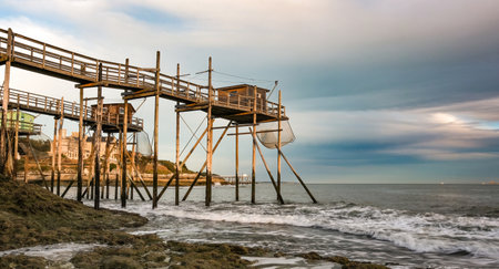 Traditional fisherman hut on stilts with carrelet fishing net. Typical wooden houses for fishing at beachの写真素材