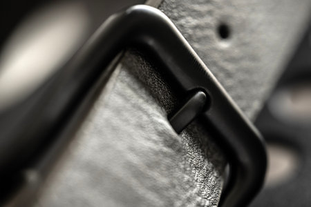 Black leather belt with metal steel buckle macro view. Clothes male accessory with elegance casual designの写真素材