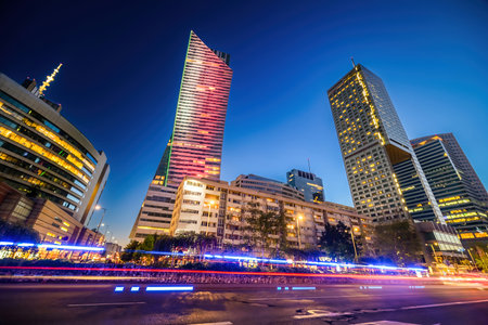 Warsaw in the evening with light trails of passing cars by the highway Road, central part of Warsaw the heart of business life in Polandの写真素材