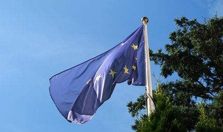 European Union Flag Waving Against The Sky Background On A Pole