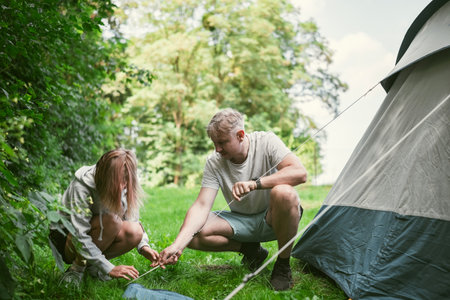 Father And Daughter Set Up A Tent At A Campground During Family Summer Camping Vacationの写真素材