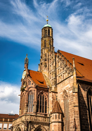 Ancient building facade Church of the Virgin Mary in old city center in Nuremberg, Germany. Historical house exterior with typical red roof in Bavaria, Europeの写真素材