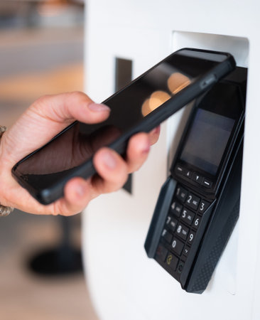 Customer Makes Contactless Payment With Smartphone At Nfc Terminal