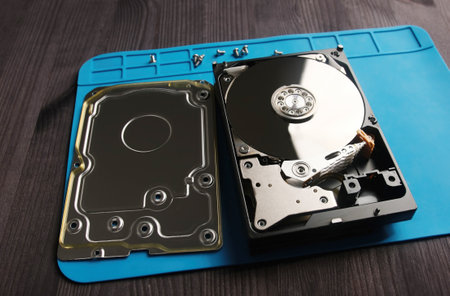 open hard data disk drive on a servicema's table in service center