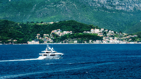 Luxury yacht in Adriatic sea, Montenegro with scenic Mediterranean landscapes and mountains. White...