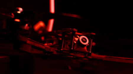 Cruise camera of fpv copter. Dron on a table in a red light.