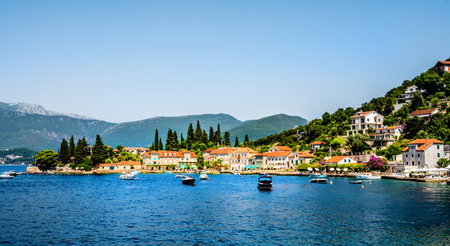 Scenic Mediterranean city Perast in Montenegro in Kotor bay, view from Adriatic sea. Beautiful architecture with mountains on backgroundの写真素材